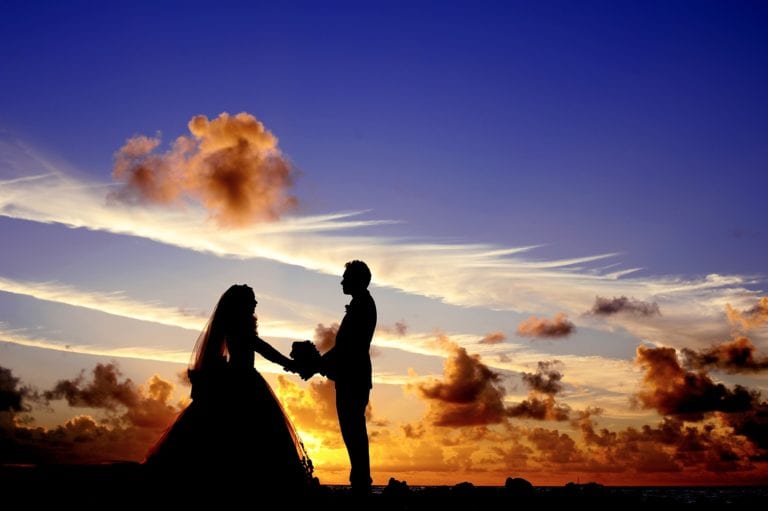 bride and groom sharing a moment at sunset